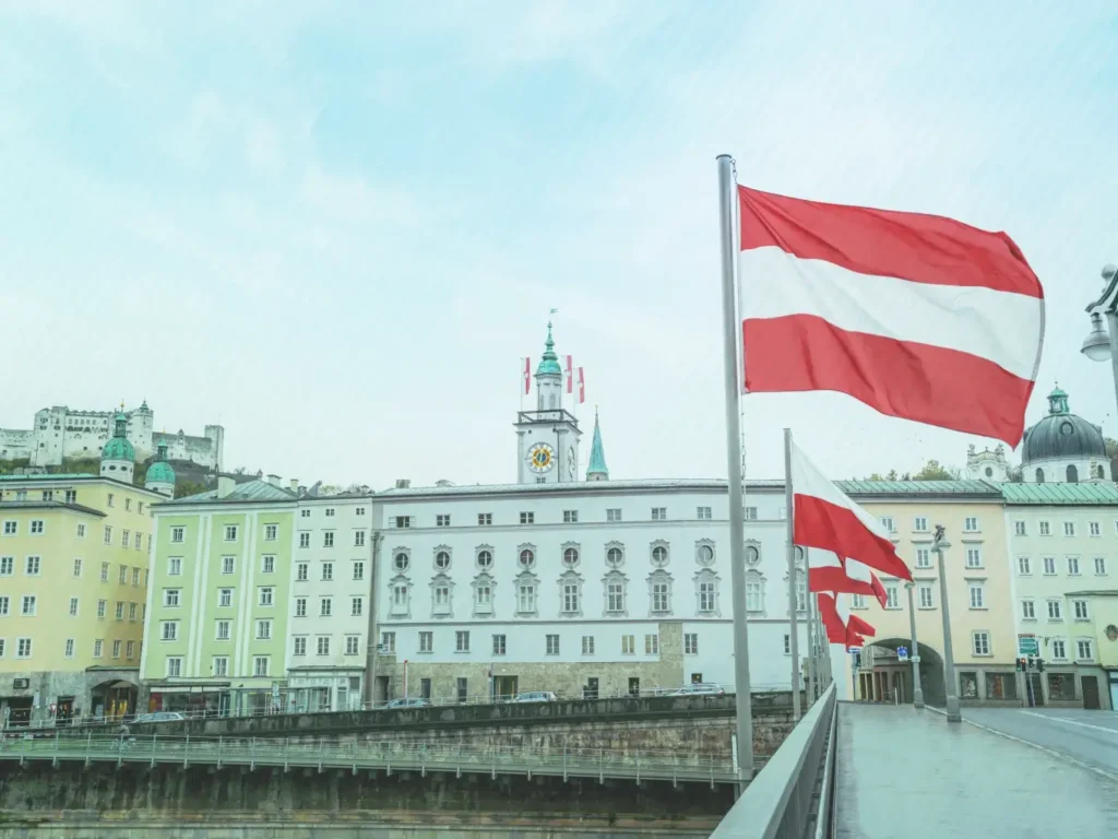 Austrian flag flying in a historic European city square
